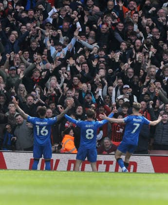 Football - 2025 2026 Premier League - Arsenal vs. AFC Bournemouth - Emirates Stadium - Saturday 11th April 2026 Alex Scott of Bournemouth (centre) celebrates scoring the winning goal with the fans 