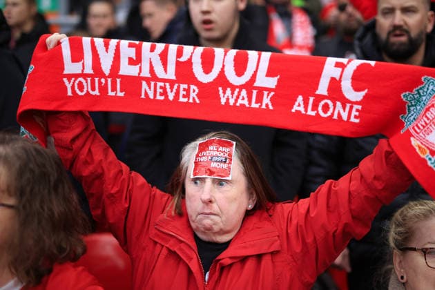 Football - Premier League - Liverpool v Fulham 11th April 2026 - Premier League - Liverpool v Fulham - A Liverpool fan holds her scarf aloft wearing a sticker protesting against rising ticket prices on her head - Photo: Simon Stacpoole Offside. Liverpool UK Copyright: xSimonxStacpoolexOffside