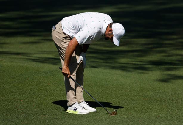 Scottie Scheffler drives his club into the grass after his pitch shot to the 15th green during the third round of the Masters Tournament at Augusta National Golf Club on Saturday, April 11, 2026, in Augusta, Georgia.  AUG20260411816 JOHNxANGELILLO