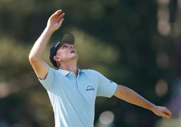 Justin Rose of England throws his ball in the air after sinking a putt for par on the 10th green during the third round of the Masters Tournament at Augusta National Golf Club on Saturday, April 11, 2026, in Augusta, Georgia.  AUG20260411827 JOHNxANGELILLO