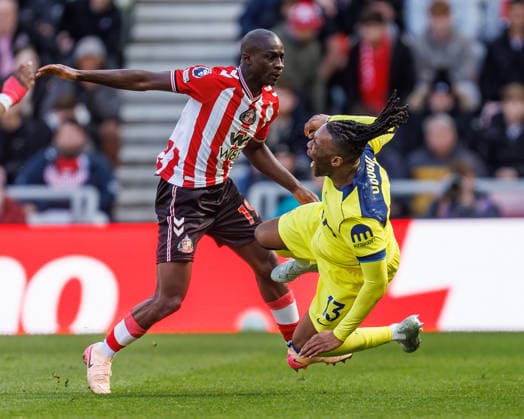 12th April 2026; Stadium of Light, Sunderland, England; Premier League Football, Sunderland versus Tottenham Hotspur; Habib Diarra of Sunderland fouls Destiny Udogie of Tottenham Hotspur WMxSportsxMedia