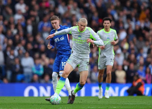 12th April 2026; Stamford Bridge, Chelsea, London, England: Premier League Football, Chelsea versus Manchester City; Erling Haaland of Manchester City under pressure from Cole Palmer of Chelsea JPxFletcher