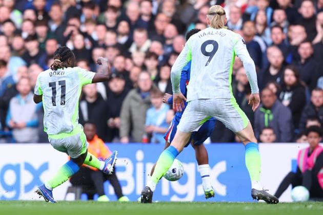 London, England, 12th April 2026. Jeremy Doku of Manchester City scores to make it 3-0 during the Chelsea vs Manchester City Premier League match at Stamford Bridge, London. Picture credit should read: Paul Terry Sportimage EDITORIAL USE ONLY. No use with unauthorised audio, video, data, fixture lists, club league logos or live services. Online in-match use limited to 120 images, no video emulation. No use in betting, games or single club league player publications. SPI_057_PT_Chelsea_Man_City SPI-4683-0057