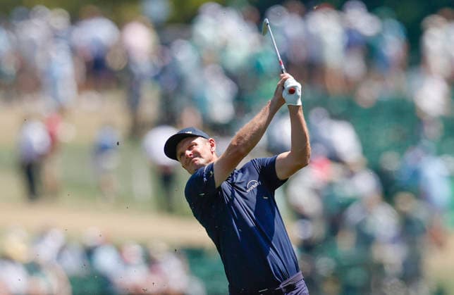 Justin Rose of England hits an approach shot to the 1st hole during the final round of the Masters Tournament at Augusta National Golf Club on Sunday, April 12, 2026, in Augusta, Georgia.  AUG20260412804 JOHNxANGELILLO