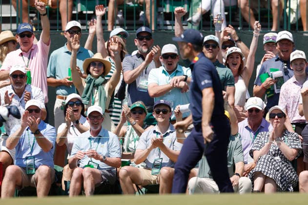 Fans react after Justin Rose of England chipped in for a birdie on the 1st hole during the final round of the Masters Tournament at Augusta National Golf Club on Sunday, April 12, 2026, in Augusta, Georgia.  AUG20260412807 JOHNxANGELILLO