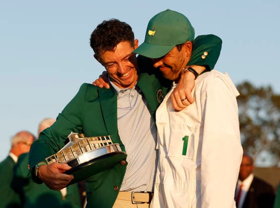 Rory McIlroy of Northern Ireland celebrates with his caddie Harry Diamond after winning the 2026 Masters Tournament at Augusta National Golf Club on Sunday, April 12, 2026, in Augusta, Georgia. McIlroy won his second consecutive Masters with a 12-under-par four-day score of 276.  AUG202604128897 JOHNxANGELILLO