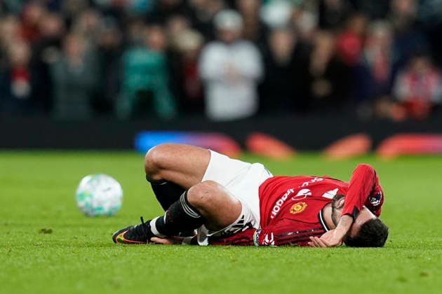Manchester, England, 13th April 2026. Bruno Fernandes of Manchester United, ManU lays in the floor in pain after a challenge from Ethan Ampadu of Leeds United during the Manchester United vs Leeds United Premier League match at Old Trafford, Manchester. Picture credit should read: Andrew Yates Sportimage EDITORIAL USE ONLY. No use with unauthorised audio, video, data, fixture lists, club league logos or live services. Online in-match use limited to 120 images, no video emulation. No use in betting, games or single club league player publications. SPI_043_AY_Man_Utd_Leeds SPI-4684-0043