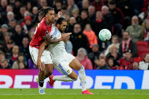 Manchester, England, 13th April 2026. Leny Yoro of Manchester United, ManU and Dominic Calvert-Lewin of Leeds United challenge for the ball during the Manchester United vs Leeds United Premier League match at Old Trafford, Manchester. Picture credit should read: Andrew Yates Sportimage EDITORIAL USE ONLY. No use with unauthorised audio, video, data, fixture lists, club league logos or live services. Online in-match use limited to 120 images, no video emulation. No use in betting, games or single club league player publications. SPI_051_AY_Man_Utd_Leeds SPI-4684-0051
