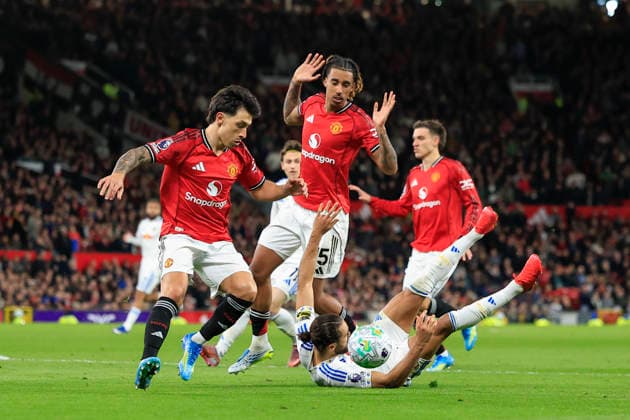 Manchester United, ManU v Leeds United, Premier League Lisandro Martinez (6) of Manchester United gathers the ball after Leny Yoro (15) of Manchester United and Dominic Calvert-Lewin (9) of Leeds United tussle during the Premier League match between Manchester United and Leeds United at Old Trafford, Manchester, UK on 13 April 2026. Manchester Old Trafford Greater Manchester UK Editorial use only DataCo restrictions apply See www.football-dataco.com , Copyright: xConorxMolloyx PSI-24063-0117