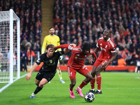 Liverpool, England, 14th April 2026. Joao Neves of Paris St Germain tussles with Jeremie Frimpong of Liverpool tussles with during the Liverpool vs Paris Saint Germain UEFA Champions League quarter final 2nd leg match at Anfield, Liverpool. Picture credit should read: Jessica Hornby Sportimage EDITORIAL USE ONLY. No use with unauthorised audio, video, data, fixture lists, club league logos or live services. Online in-match use limited to 120 images, no video emulation. No use in betting, games or single club league player publications. SPI_065_JH_Liverpool_PSG SPI-4687-0065