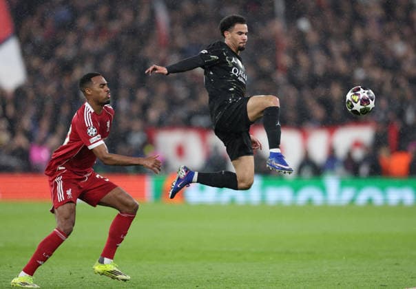 Liverpool, England, 14th April 2026. Warren Zaire-Emery of Paris St Germain (r) leaps up to get to the ball before Ryan Gravenberch of Liverpool (l) during the Liverpool vs Paris Saint Germain UEFA Champions League quarter final 2nd leg match at Anfield, Liverpool. Picture credit should read: Jessica Hornby Sportimage EDITORIAL USE ONLY. No use with unauthorised audio, video, data, fixture lists, club league logos or live services. Online in-match use limited to 120 images, no video emulation. No use in betting, games or single club league player publications. SPI_077_JH_Liverpool_PSG SPI-4687-0078