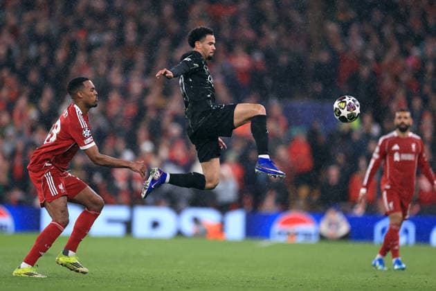 Liverpool v Paris Saint-Germain 14th April 2026 - UEFA Champions League - Quarter Final (2nd Leg) - Liverpool v Paris Saint-Germain - Warren Zaire-Emery of Paris Saint-Germain leaps to control the ball watched by Ryan Gravenberch of Liverpool - Photo: Simon Stacpoole Offside. Liverpool UK Copyright: xSimonxStacpoolexOffside