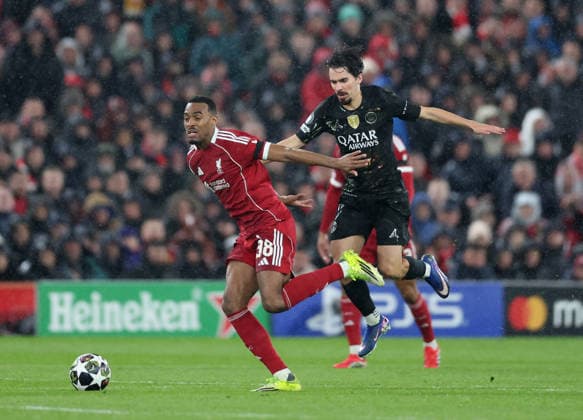 Liverpool, England, 14th April 2026. Ryan Gravenberch of Liverpool (l) and Khvicha Kvaratskhelia of Paris Saint-Germain during the Liverpool vs Paris Saint Germain UEFA Champions League quarter final 2nd leg match at Anfield, Liverpool. Picture credit should read: Jessica Hornby Sportimage EDITORIAL USE ONLY. No use with unauthorised audio, video, data, fixture lists, club league logos or live services. Online in-match use limited to 120 images, no video emulation. No use in betting, games or single club league player publications. SPI_090_JH_Liverpool_PSG SPI-4687-0090
