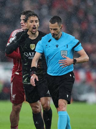 Liverpool, England, 14th April 2026. Marquinhos of Paris Saint-Germain challenges referee Maurizio Mariani after he awarded Liverpool a penalty during the Liverpool vs Paris Saint Germain UEFA Champions League quarter final 2nd leg match at Anfield, Liverpool. Picture credit should read: Jessica Hornby Sportimage EDITORIAL USE ONLY. No use with unauthorised audio, video, data, fixture lists, club league logos or live services. Online in-match use limited to 120 images, no video emulation. No use in betting, games or single club league player publications. SPI_092_JH_Liverpool_PSG SPI-4687-0092