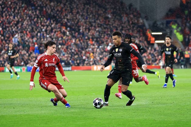 Liverpool, England, 14th April 2026. Desire Doue of Paris Saint-Germain runs with the ball whilst under pressure from Milos Kerkez of Liverpool during the Liverpool vs Paris Saint Germain UEFA Champions League quarter final 2nd leg match at Anfield, Liverpool. Picture credit should read: Jessica Hornby Sportimage EDITORIAL USE ONLY. No use with unauthorised audio, video, data, fixture lists, club league logos or live services. Online in-match use limited to 120 images, no video emulation. No use in betting, games or single club league player publications. SPI_117_JH_LIVERPOOL_PSG SPI-4687-0117