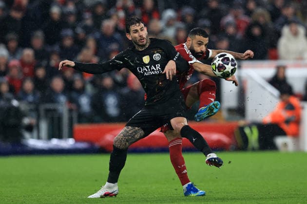 RECORD DATE NOT STATED 14th April 2026; Anfield, Liverpool, Merseyside, England; UEFA Champions League Football, Liverpool versus Paris Saint Germain; Mohammed Salah of Liverpool passes the ball under pressure from Lucas Hernandez of PSG DavidxBlunsden