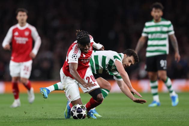 London, England, 15th April 2026. Noni Madueke of Arsenal and Pedro Goncalves of Sporting Lisbon challenge for the ball during the Arsenal vs Sporting Lisbon UEFA Champions League quarter final 2nd leg match at the Emirates Stadium, London. Picture credit should read: David Klein Sportimage EDITORIAL USE ONLY. No use with unauthorised audio, video, data, fixture lists, club league logos or live services. Online in-match use limited to 120 images, no video emulation. No use in betting, games or single club league player publications. SPI_030_DK_Arsenal_Sporting_Lisbon SPI-4686-0030
