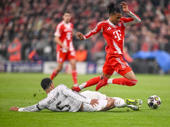 Jude Bellingham (Real Madrid) and Michael Olise (FC Bayern München) battle for the ball during the UEFA Champions League 2025 26 Quarter-Final Second Leg match between FC Bayern München and Real Madrid CF at Football Arena Munich on April 15, 2026 in Munich, Germany. (Photo by Harry Langer DeFodi Images) -