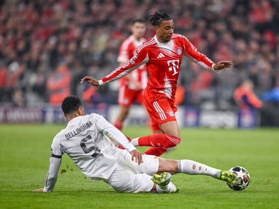 Jude Bellingham (Real Madrid) and Michael Olise (FC Bayern München) battle for the ball during the UEFA Champions League 2025 26 Quarter-Final Second Leg match between FC Bayern München and Real Madrid CF at Football Arena Munich on April 15, 2026 in Munich, Germany. (Photo by Harry Langer DeFodi Images) -