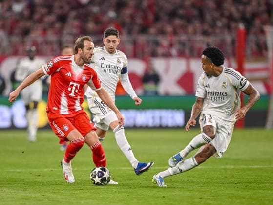 Harry Kane (FC Bayern München), Federico Valverde (Real Madrid) and Eder Militae (Real Madrid) battle for the ball during the UEFA Champions League 2025 26 Quarter-Final Second Leg match between FC Bayern München and Real Madrid CF at Football Arena Munich on April 15, 2026 in Munich, Germany. (Photo by Harry Langer DeFodi Images) -