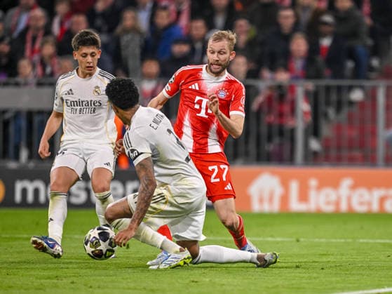 Arda Güler (Real Madrid), Eder Militae (Real Madrid) and Konrad Laimer (FC Bayern München) battle for the ball during the UEFA Champions League 2025 26 Quarter-Final Second Leg match between FC Bayern München and Real Madrid CF at Football Arena Munich on April 15, 2026 in Munich, Germany. (Photo by Harry Langer DeFodi Images) -