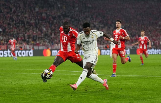 Dayot Upamecano (Bayern Munich) and Vinicius Junior (Real Madrid) battle for the ball during Bayern Munich and Real Madrid, UEFA Champions league Quarter Final UEFA Champions League, at Allianz Arena, Munich, Germany on April 15, 2026. Thor Wegner DeFodi Images. (Photo by DeFodi Images) -