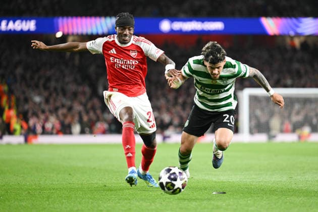Noni Madueke of Arsenal FC and Maxi Araujo of Sporting challenge during the UEFA Champions League match between Arsenal and Sporting CP at the Emirates Stadium, London, England on 15 April 2026. Copyright: xPhilxHutchinsonx 44830036