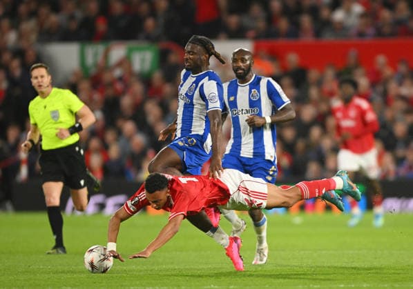 Nottingham, England, 16th April 2026. Dan Ndoye of Nottingham Forest fouled by Terem Moffi of FC Porto during the Nottingham Forest vs FC Porto UEFA Europa League quarter final 2nd leg match at the City Ground, Nottingham. Picture credit should read: Harriet Massey Sportimage EDITORIAL USE ONLY. No use with unauthorised audio, video, data, fixture lists, club league logos or live services. Online in-match use limited to 120 images, no video emulation. No use in betting, games or single club league player publications. SPI_036_FOREST_V_PORTO SPI-4690-0039