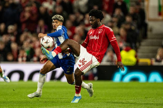 RECORD DATE NOT STATED 16th April 2026; The City Ground, Nottingham, England; UEFA Europa League Football, Nottingham Forest versus Porto; Ola Aina of Nottingham Forest controls a high ball under pressure from William Gomes of FC Porto GodfreyxPitt