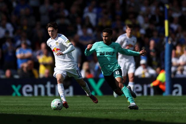 Leeds, England, 18th April 2026. Brenden Aaronson of Leeds United is challenged by Joao Gomes of Wolverhampton Wanderers during the Leeds United vs Wolverhampton Wanderers Premier League match at Elland Road, Leeds. Picture credit should read: Jessica Hornby Sportimage EDITORIAL USE ONLY. No use with unauthorised audio, video, data, fixture lists, club league logos or live services. Online in-match use limited to 120 images, no video emulation. No use in betting, games or single club league player publications. SPI_037_JH_LEEDS_UNITED_WOLVES SPI-4700-0037