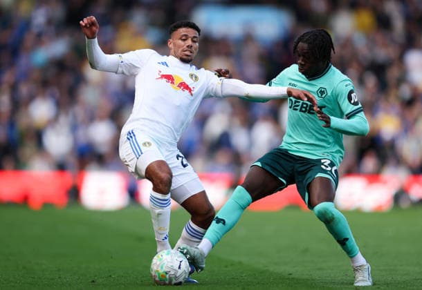Leeds, England, 18th April 2026. James Justin of Leeds United is challenged by Mateus Mane of Wolverhampton Wanderers during the Leeds United vs Wolverhampton Wanderers Premier League match at Elland Road, Leeds. Picture credit should read: Jessica Hornby Sportimage EDITORIAL USE ONLY. No use with unauthorised audio, video, data, fixture lists, club league logos or live services. Online in-match use limited to 120 images, no video emulation. No use in betting, games or single club league player publications. SPI_042_JH_LEEDS_UNITED_WOLVES SPI-4700-0042