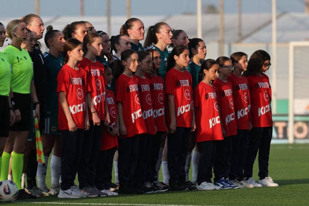 Northern Ireland players (back) stand with girls player escorts during the playing of their country™s national anthem ahead of the FIFA Women™s World Cup 2027 European qualifiers League B, Group B2 soccer match between Malta and Nothern Ireland at the Centenary Stadium, Ta™ Qali, Malta on 18 April 2026. Women™s European Qualifiers - Malta v Northern Ireland