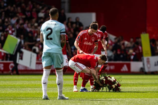 19th April 2026; The City Ground, Nottingham, England; Premier League Football, Nottingham Forest versus Burnley; Elliot Anderson of Nottingham Forest lays a wreath before kick-off in memory of his mother who passed away this week. GodfreyxPitt