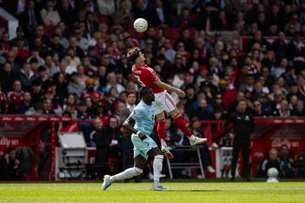 19th April 2026; The City Ground, Nottingham, England; Premier League Football, Nottingham Forest versus Burnley; Neco Williams of Nottingham Forest wins an aerial duel with Lesley Ugochukwu of Burnley GodfreyxPitt