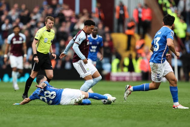 Birmingham, England, 19th April 2026. Enzo Le FÃ e of Sunderland tackles Jadon Sancho of Aston Villa during the Aston Villa vs Sunderland Premier League match at Villa Park, Birmingham. Picture credit should read: Gareth Evans Sportimage EDITORIAL USE ONLY. No use with unauthorised audio, video, data, fixture lists, club league logos or live services. Online in-match use limited to 120 images, no video emulation. No use in betting, games or single club league player publications. SPI_051_GE_Aston_Villa_vs_Sunderland SPI-4703-0051