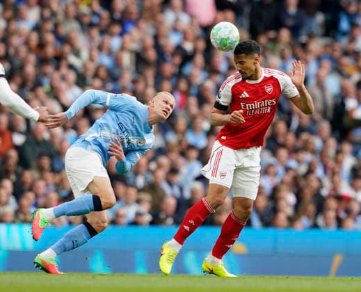 Manchester, England, 19th April 2026. Erling Haaland of Manchester City and William Saliba of Arsenal during the Manchester City vs Arsenal Premier League match at the Etihad Stadium, Manchester. Picture credit should read: Andrew Yates Sportimage EDITORIAL USE ONLY. No use with unauthorised audio, video, data, fixture lists, club league logos or live services. Online in-match use limited to 120 images, no video emulation. No use in betting, games or single club league player publications. SPI_040_AY_Man_City_Arsenal SPI-4704-0040