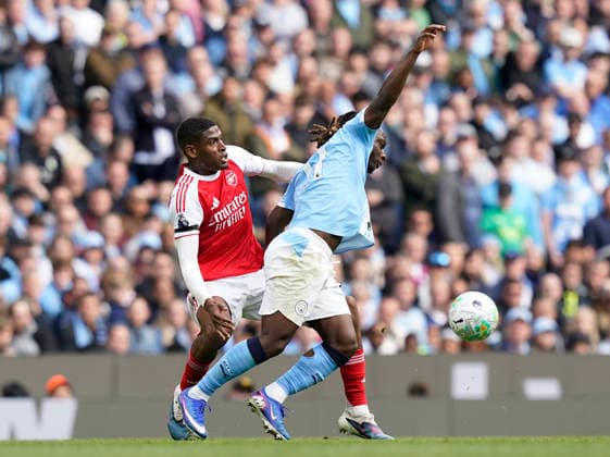 Manchester, England, 19th April 2026. Cristhian Mosquera of Arsenal pulls back Jeremy Doku of Manchester City and receives a yellow card during the Manchester City vs Arsenal Premier League match at the Etihad Stadium, Manchester. Picture credit should read: Andrew Yates Sportimage EDITORIAL USE ONLY. No use with unauthorised audio, video, data, fixture lists, club league logos or live services. Online in-match use limited to 120 images, no video emulation. No use in betting, games or single club league player publications. SPI_056_AY_Man_City_Arsenal SPI-4704-0055