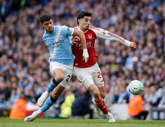 Manchester, England, 19th April 2026. Matheus Nunes of Manchester City tussles with Kai Havertz of Arsenal during the Manchester City vs Arsenal Premier League match at the Etihad Stadium, Manchester. Picture credit should read: Andrew Yates Sportimage EDITORIAL USE ONLY. No use with unauthorised audio, video, data, fixture lists, club league logos or live services. Online in-match use limited to 120 images, no video emulation. No use in betting, games or single club league player publications. SPI_063_AY_Man_City_Arsenal SPI-4704-0062