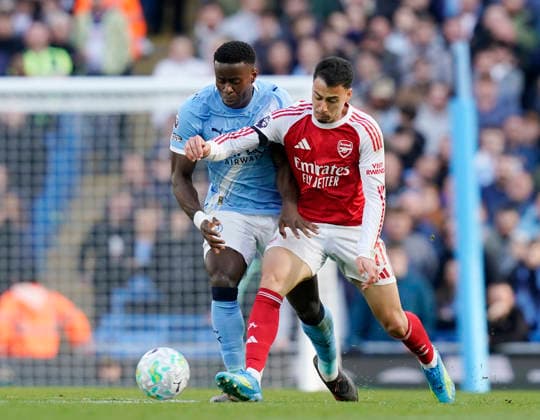 Manchester, England, 19th April 2026. Marc Guehi of Manchester City tackles Gabriel Martinelli of Arsenal during the Manchester City vs Arsenal Premier League match at the Etihad Stadium, Manchester. Picture credit should read: Andrew Yates Sportimage EDITORIAL USE ONLY. No use with unauthorised audio, video, data, fixture lists, club league logos or live services. Online in-match use limited to 120 images, no video emulation. No use in betting, games or single club league player publications. SPI_085_AY_Man_City_Arsenal SPI-4704-0084