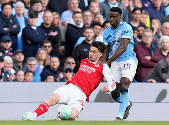 Manchester, England, 19th April 2026. Kai Havertz of Arsenal tussles with Marc Guehi of Manchester City during the Manchester City vs Arsenal Premier League match at the Etihad Stadium, Manchester. Picture credit should read: Andrew Yates Sportimage EDITORIAL USE ONLY. No use with unauthorised audio, video, data, fixture lists, club league logos or live services. Online in-match use limited to 120 images, no video emulation. No use in betting, games or single club league player publications. SPI_098_AY_Man_City_Arsenal SPI-4704-0097
