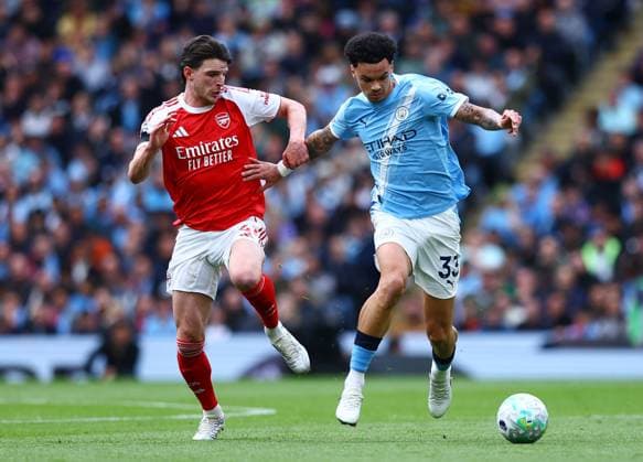Nico O Reilly of Manchester City and Declan Rice of Arsenal Manchester City v Arsenal, Premier League, Football, Etihad Stadium, Manchester, UK - 19 Apr 2026Manchester Etihad Stadium United Kingdom EDITORIAL USE ONLY No use with unauthorised audio, video, data, fixture lists, club league logos or live services. Online in-match use limited to 120 images, no video emulation. No use in betting, games or single club league player publications.  Copyright: xMattxWest Shutterstockx 16836204cd