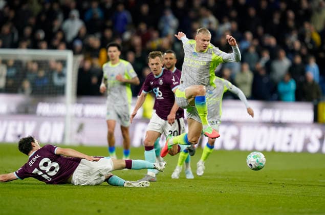 Burnley, England, 22nd April 2026. Erling Haaland of Manchester City (R) evades a challenge from Hjalmar Ekdal of Burnley during the Burnley vs Manchester City Premier League match at Turf Moor, Burnley. Picture credit should read: Andrew Yates Sportimage EDITORIAL USE ONLY. No use with unauthorised audio, video, data, fixture lists, club league logos or live services. Online in-match use limited to 120 images, no video emulation. No use in betting, games or single club league player publications. SPI_022_AY_BURNLEY_MAN_CITY SPI-4716-0022
