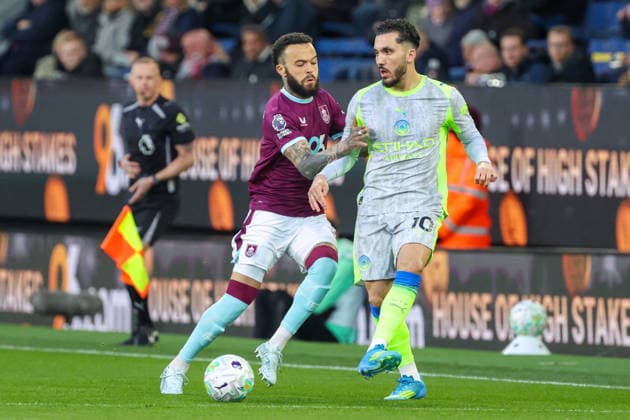 22nd April 2026; Turf Moor, Burnley, Lancashire, England; Premier League Football, Burnley versus Manchester City; Rayan Cherki of Manchester City makes a pass whilst under pressure from Quilindschy Hartman of Burnley AidanxHunter