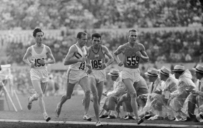 Rome, Italy. Athletes Kazimierz Zimny (Poland) (L), Rhadi Ben Abdesselam (Morocco) (2nd R) and Pyotr Bolotnikov (USSR) (R) run at the 10,000 metres event during the 1960 Summer Olympics. Soviet athlete Bolotnikov came first. Viktor Koshevoi TASS  32395180