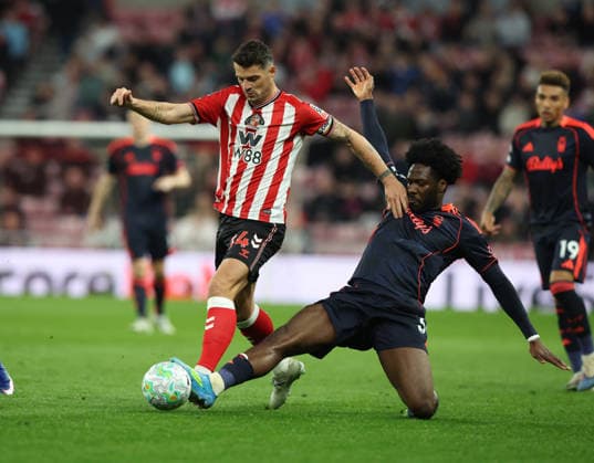 Sunderland, England, 24th April 2026. Granit Xhaka (L) of Sunderland in action with Ola Aina of Nottingham Forest during the Sunderland vs Nottingham Forest Premier League match at the Stadium Of Light, Sunderland. Picture credit should read: Nigel Roddis Sportimage EDITORIAL USE ONLY. No use with unauthorised audio, video, data, fixture lists, club league logos or live services. Online in-match use limited to 120 images, no video emulation. No use in betting, games or single club league player publications. SPI_032_NR_SUND_NOTT SPI-4720-0031
