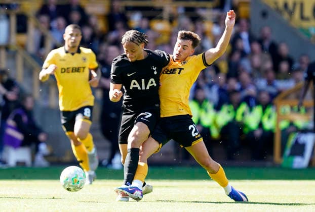 Wolverhampton, England, 25th April 2026. Xavi Simons of Tottenham (L) is challenged by Rodrigo Gomes of Wolverhampton Wanderers during the Wolverhampton Wanderers vs Tottenham Hotspur Premier League match at Molineux, Wolverhampton. Picture credit should read: Andrew Yates Sportimage EDITORIAL USE ONLY. No use with unauthorised audio, video, data, fixture lists, club league logos or live services. Online in-match use limited to 120 images, no video emulation. No use in betting, games or single club league player publications. SPI_015_AY_WOLVES_SPURS SPI-4731-0014