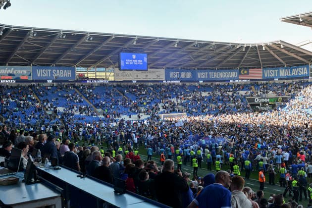 Football - 2025 2026 EFL Sky Bet League One - Cardiff City vs. Northampton Town - Cardiff City Stadium - Saturday 24th April 2026 pITCH INVASION BY CARDIFF FANS HOLDS UP PRESENTATION Pic- COLORSPORT Winston Bynorth 