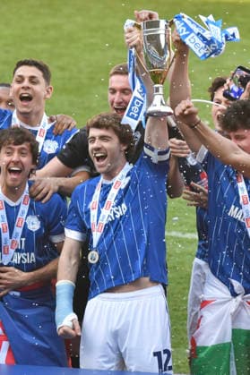 Football - 2025 2026 EFL Sky Bet League One - Cardiff City vs. Northampton Town - Cardiff City Stadium - Saturday 24th April 2026 Rubin Colwill, CAPT, CARDIFF CITY RAISES THE TROPHY AS cARDIFF CELEBRATE PROMOTION Pic- COLORSPORT Winston Bynorth 