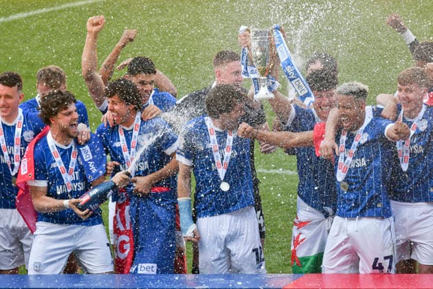 Football - 2025 2026 EFL Sky Bet League One - Cardiff City vs. Northampton Town - Cardiff City Stadium - Saturday 24th April 2026 Rubin Colwill, CAPT, CARDIFF CITY RAISES THE TROPHY AS cARDIFF CELEBRATE PROMOTION WITH CHAMPAGNE Pic- COLORSPORT Winston Bynorth 