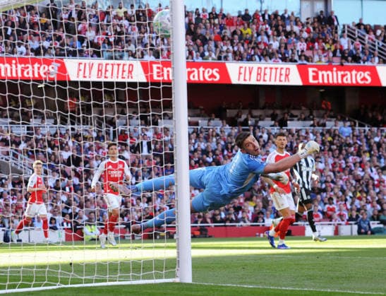 Football - 2025 2026 Premier League - Arsenal vs. Newcastle United - Emirates Stadium - Saturday 25th April 2026 Newcastle goalkeeper, Nick Pope can only dive in vain as Eberechi Eze™s shot goes into the net for Arsenal™s first half goal 